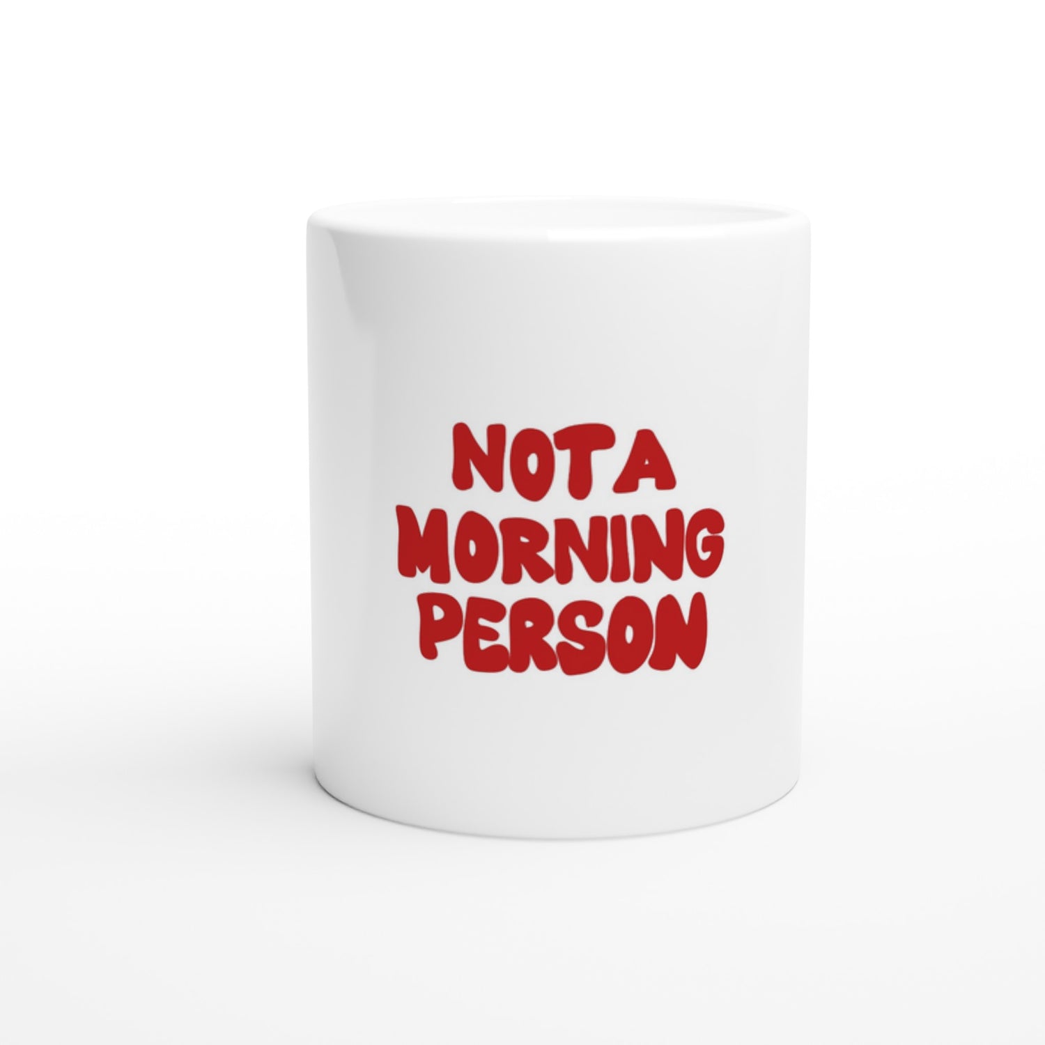 White ceramic coffee mug with bold red text that reads "NOT A MORNING PERSON." A perfect gift for those who hate early mornings, featuring a playful and relatable design.